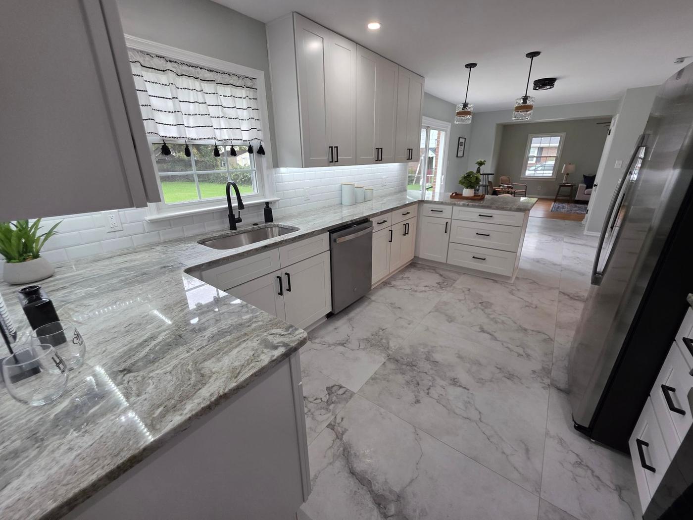 Kitchen remodel with white shaker cabinets, granite countertops, subway tile backsplash, and marble-look tile floor in Hampton Roads VA